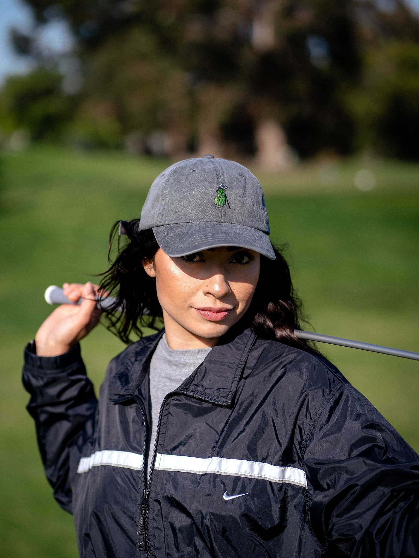 A golfer in a cap with a club over the shoulder