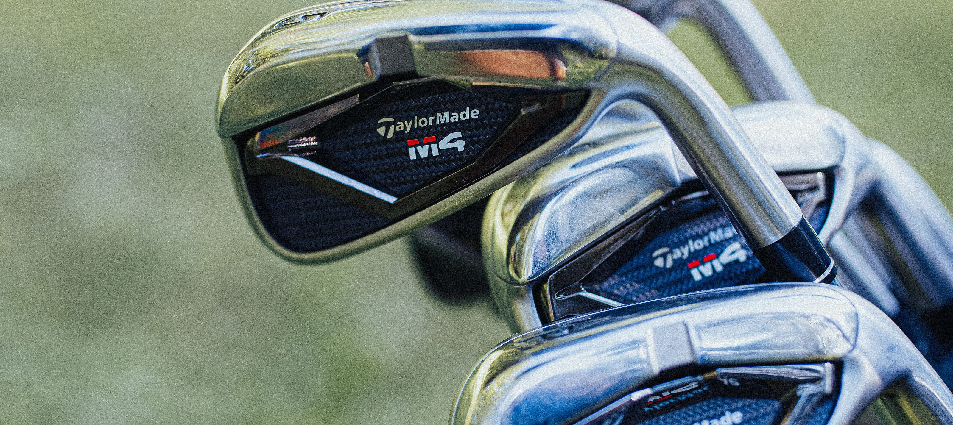 TaylorMade irons standing in a bag on the course