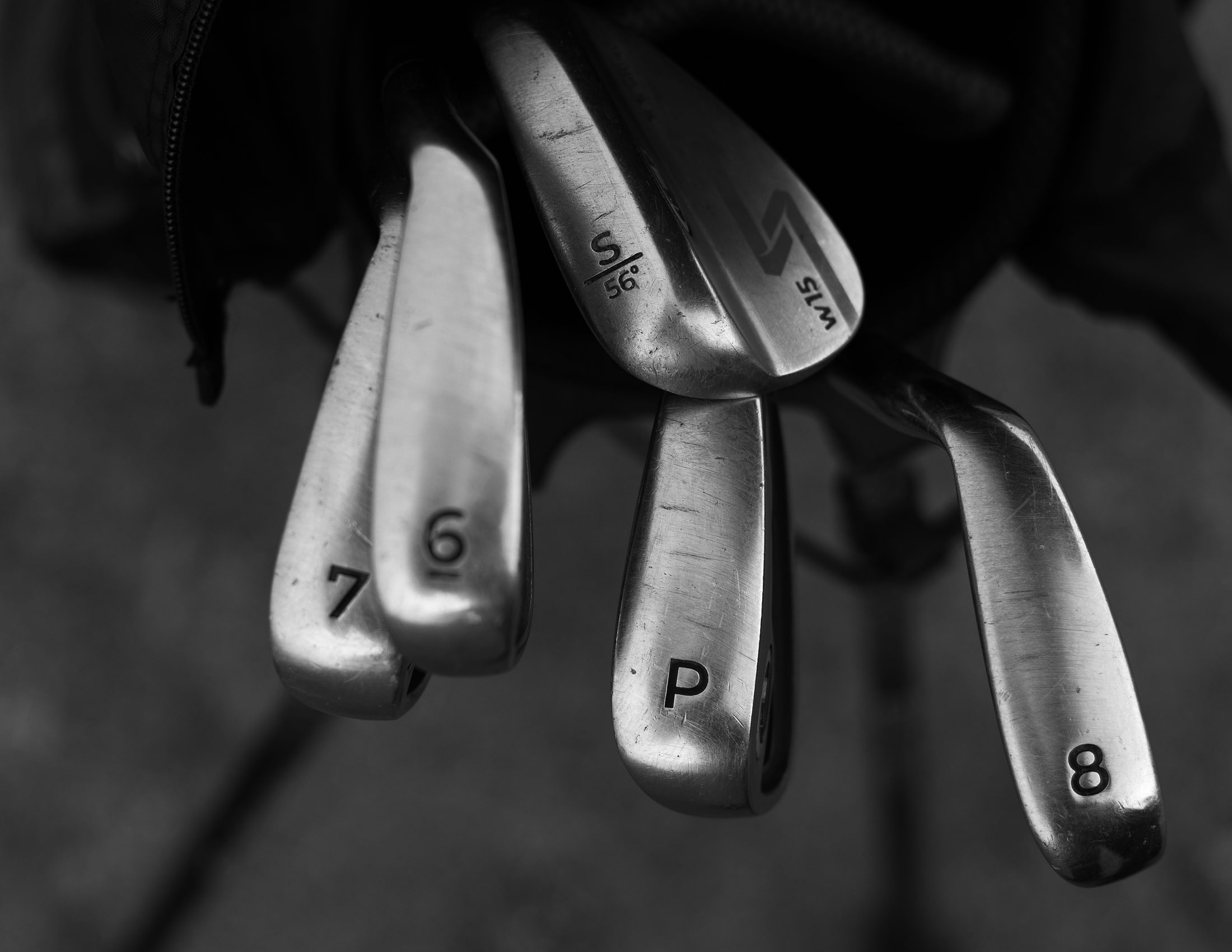 Iron heads stamped seven, six, pitching and eight standing in a bag, in black and white