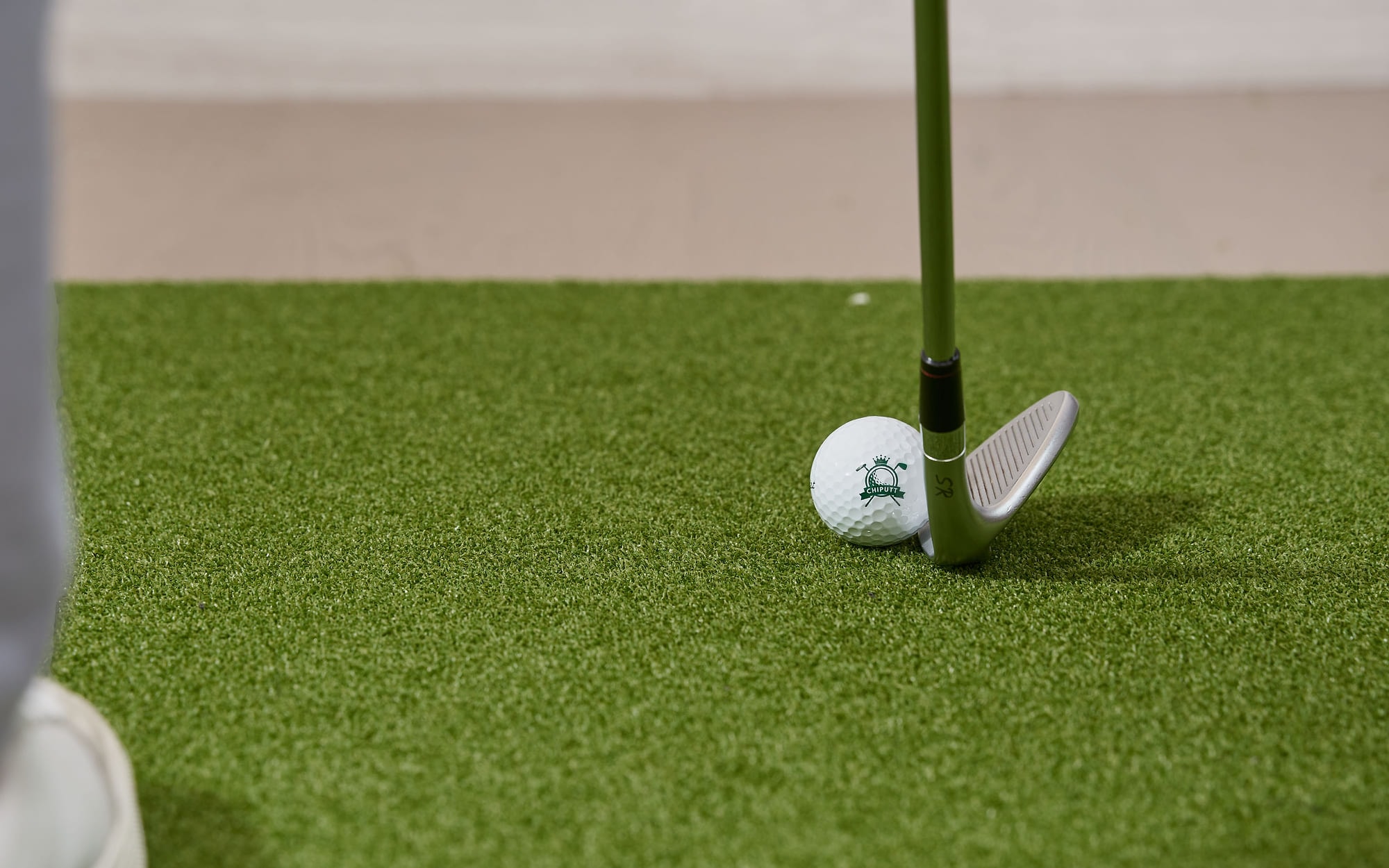 A wedge set behind a ball on the studio mat