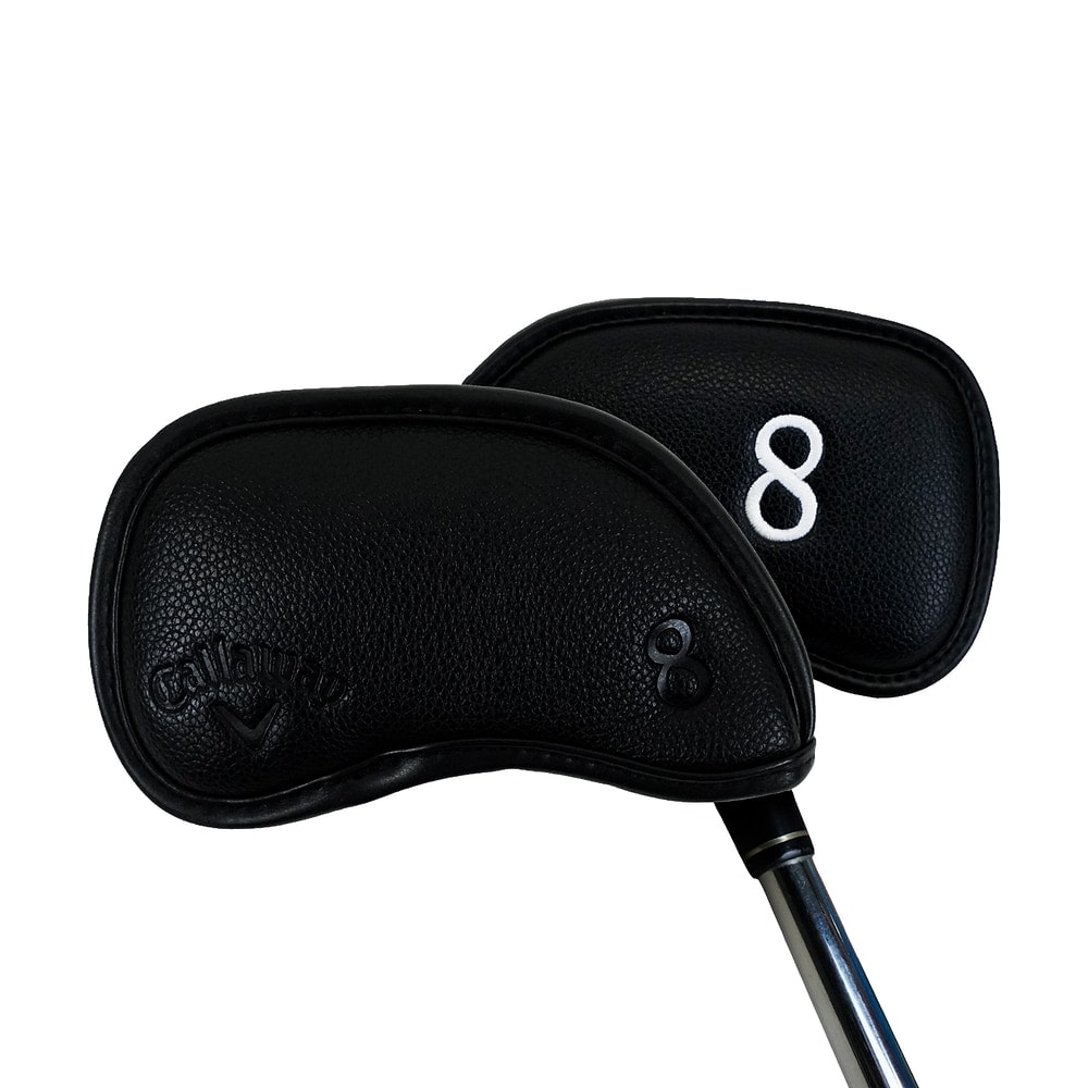 A black Callaway magnetic iron headcover on an iron, on white