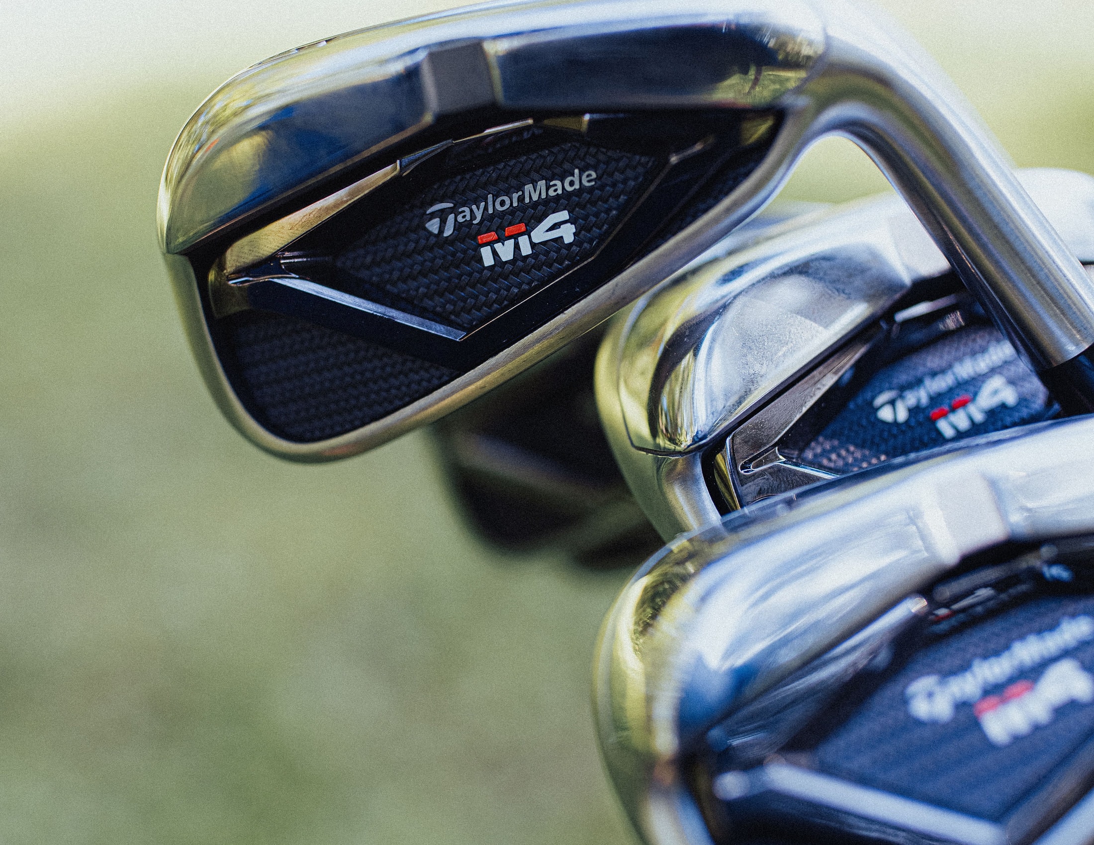 A row of TaylorMade iron heads in close up