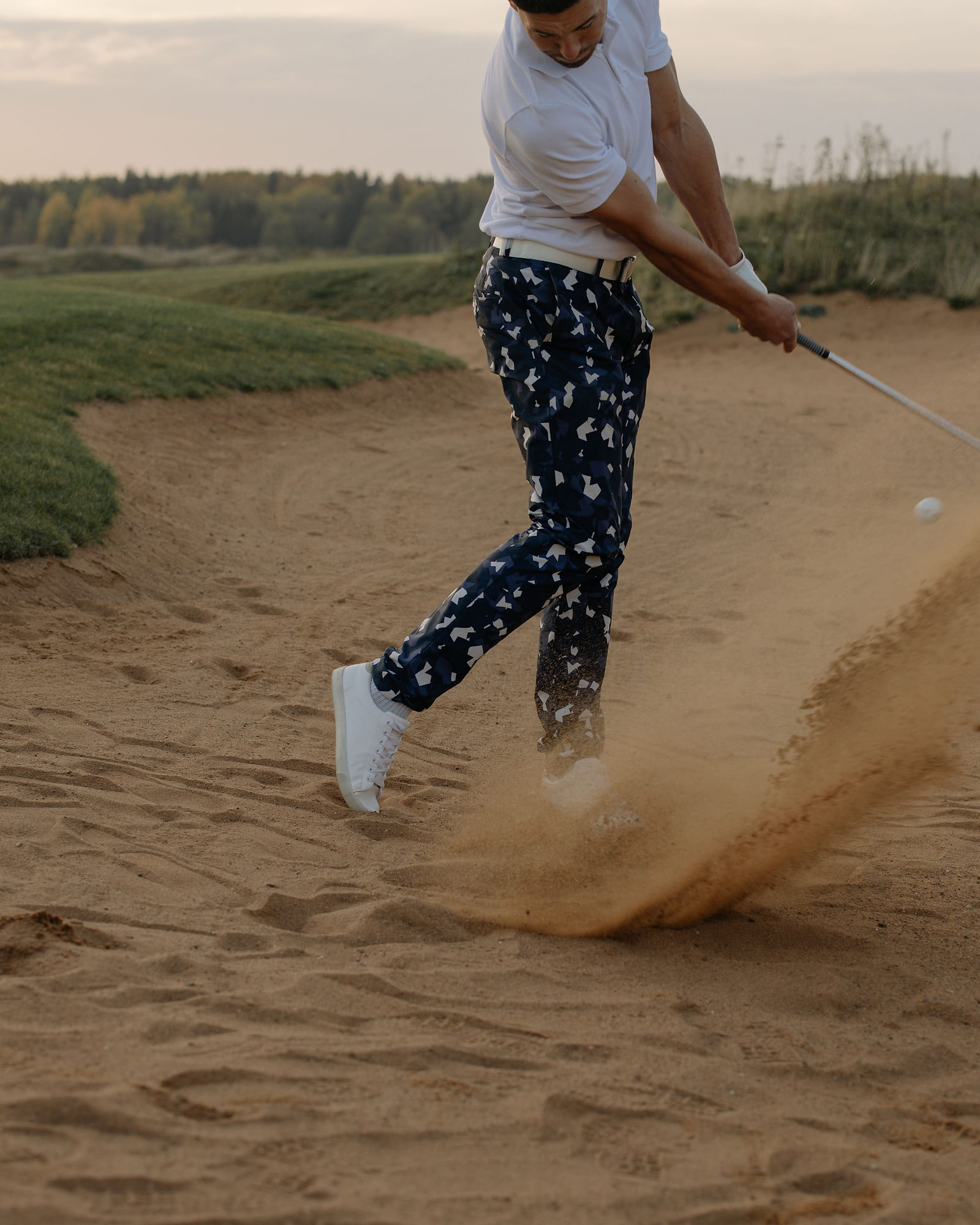 A wedge moving a wall of sand out of a links bunker