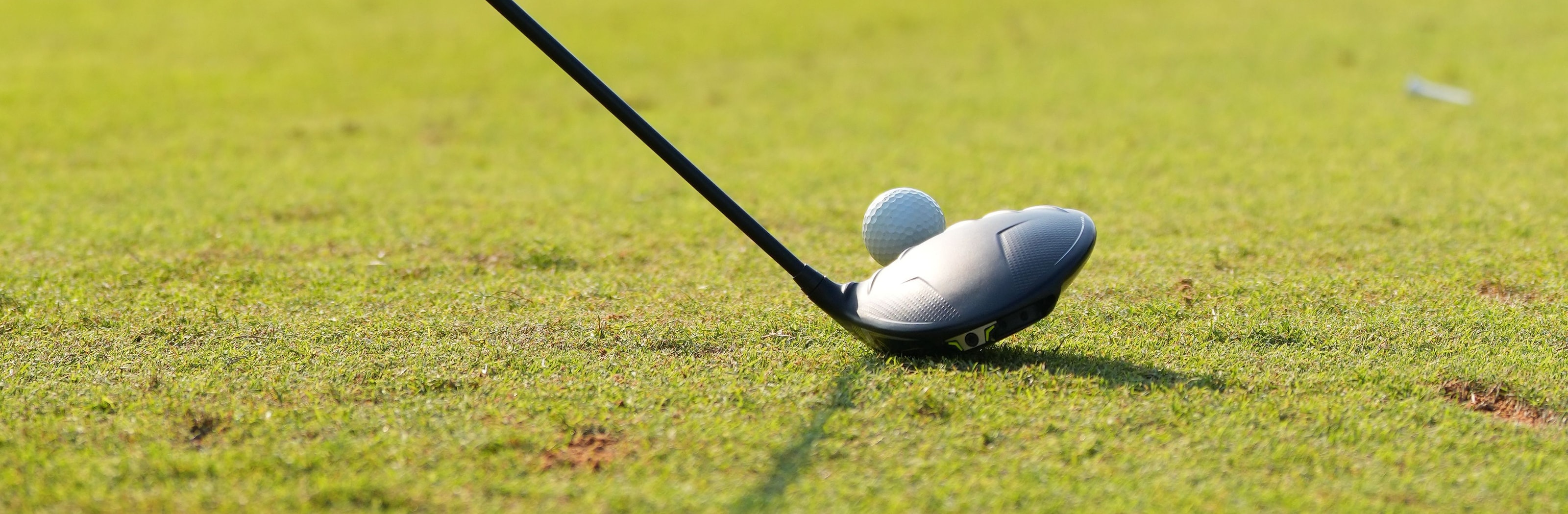 A hybrid set behind a ball on cut grass