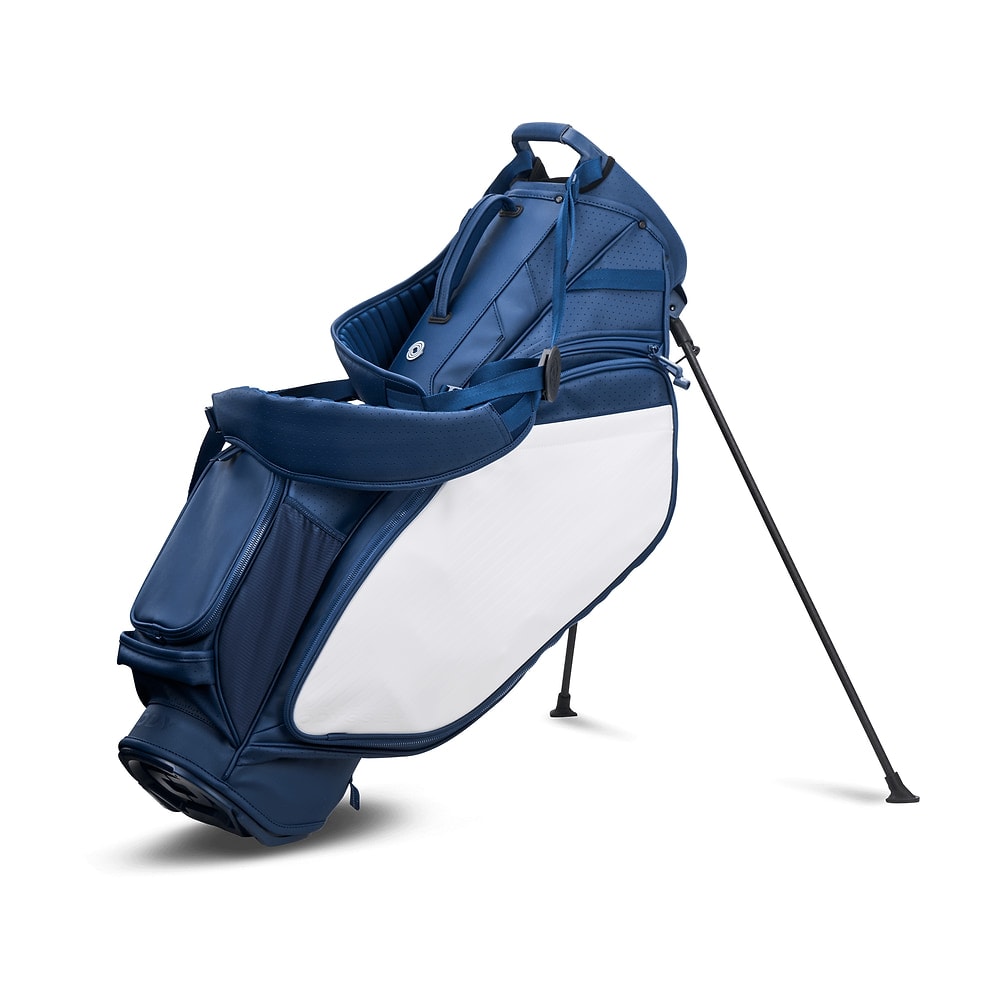 A navy and white Odyssey Shadow stand bag, legs out, on white