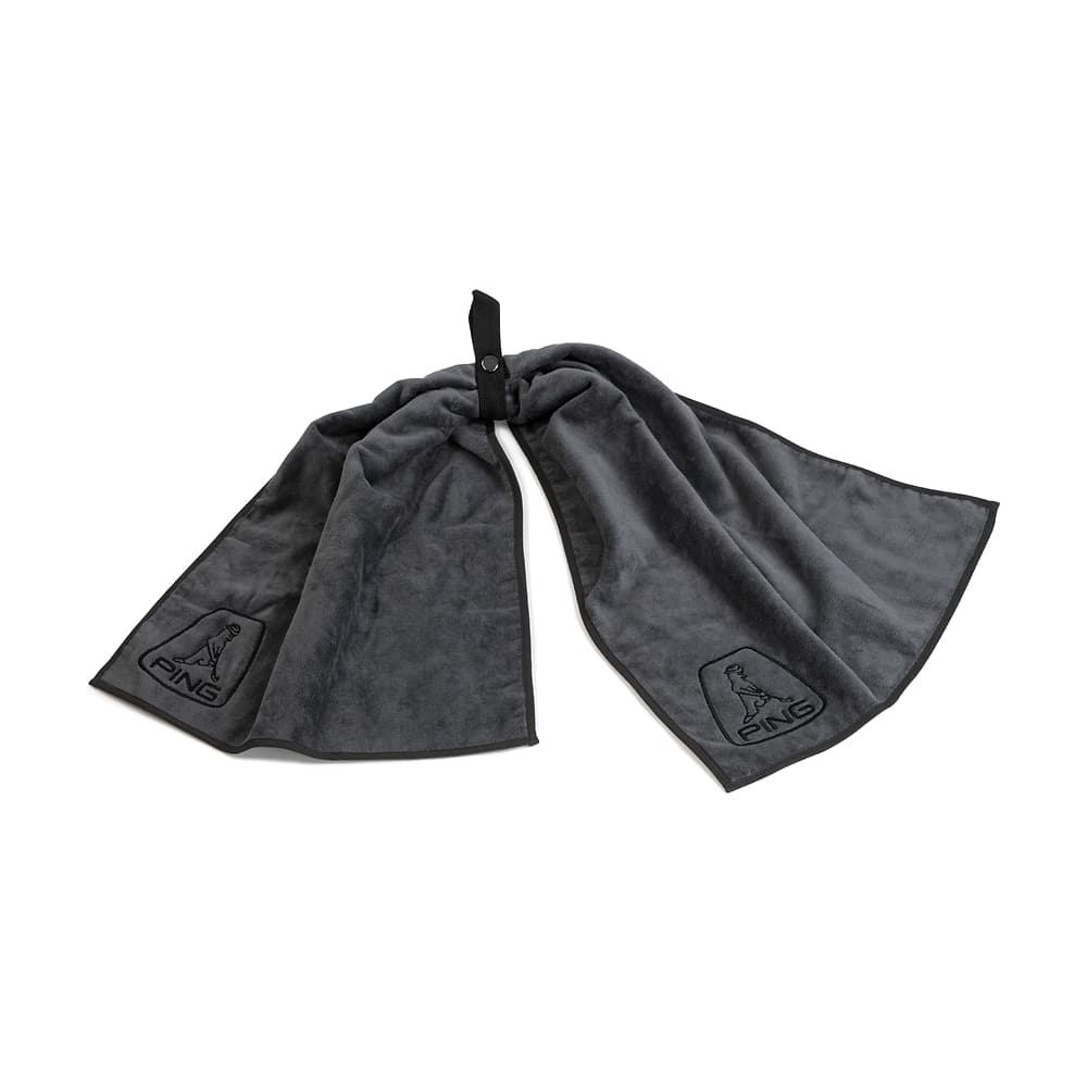 A Ping bow tie golf towel laid flat, on white